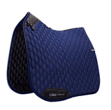 Blue quilted saddle pad with black accents on a white background