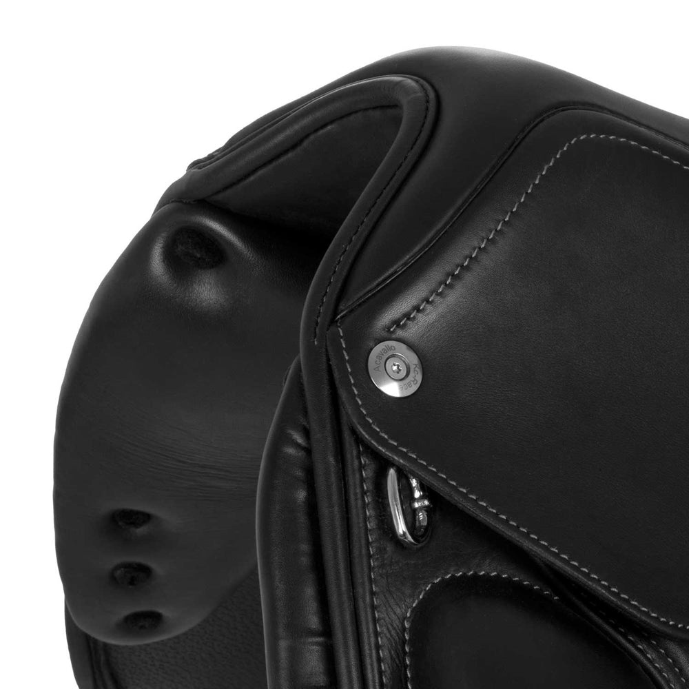 Close-up of a black leather saddle with stitching details on a white background