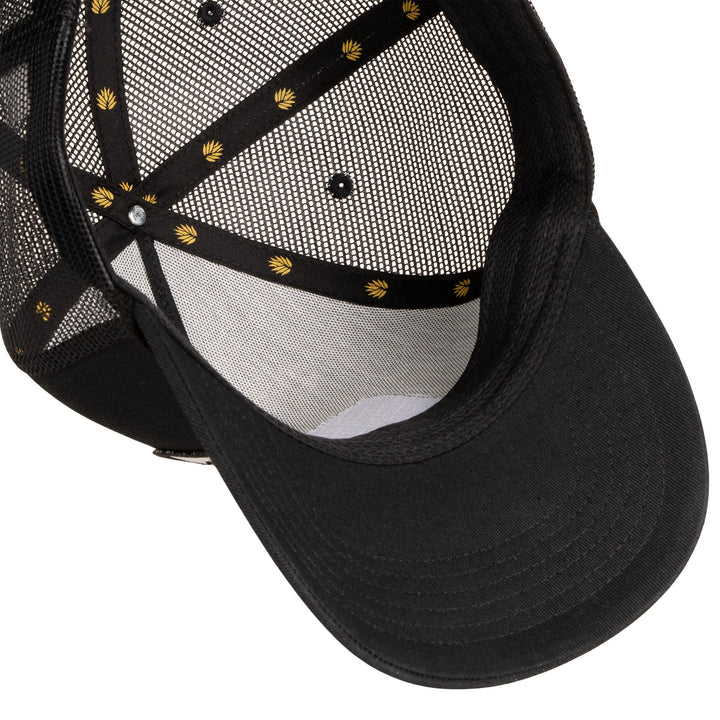 Black cap with mesh back and decorative elements on a white background
